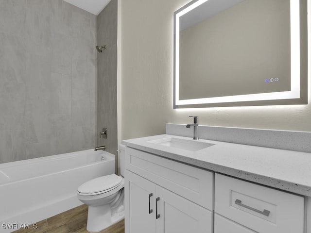 bathroom featuring shower / bath combination, vanity, toilet, and wood finished floors