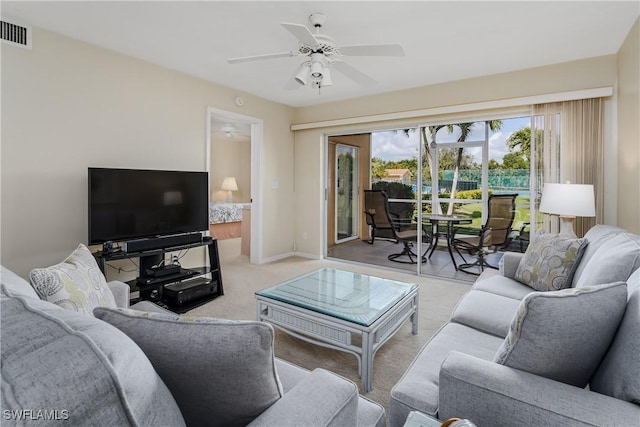 carpeted living room featuring ceiling fan