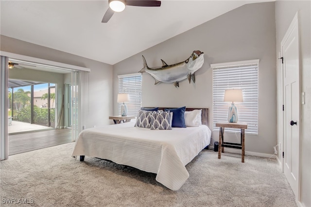 carpeted bedroom with ceiling fan, access to exterior, vaulted ceiling, and multiple windows