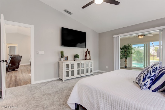 bedroom featuring ceiling fan, vaulted ceiling, and carpet floors