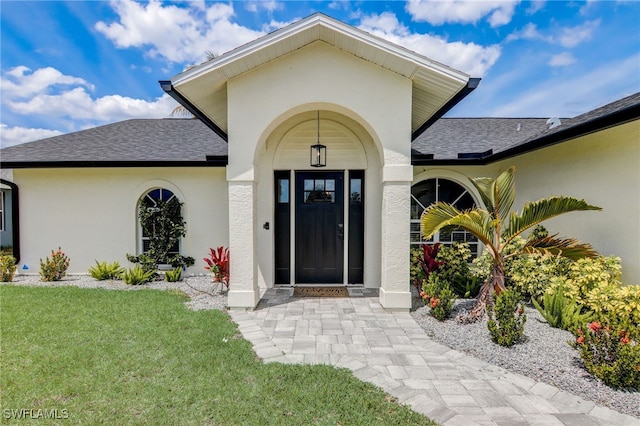 entrance to property featuring a yard