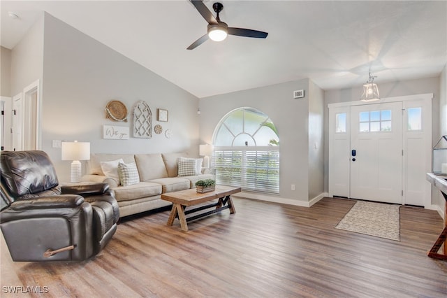 living room featuring lofted ceiling, wood-type flooring, and ceiling fan