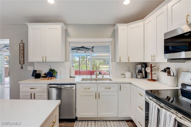 kitchen featuring white cabinets, backsplash, sink, and stainless steel appliances