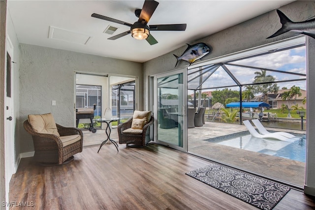 sunroom / solarium featuring ceiling fan