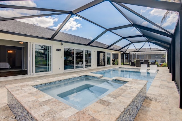 view of swimming pool featuring a patio, glass enclosure, and an in ground hot tub