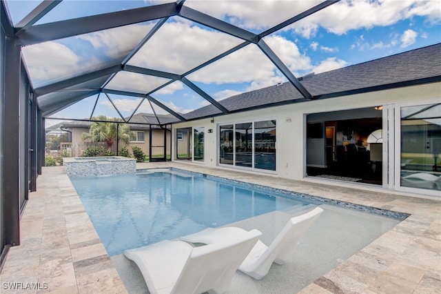 view of pool featuring a patio, glass enclosure, and an in ground hot tub