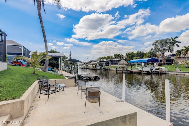 view of dock with a water view and a lawn