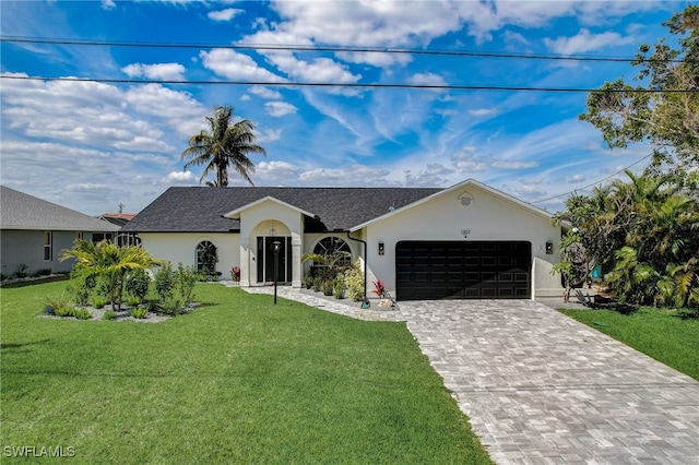 ranch-style house featuring a front yard and a garage