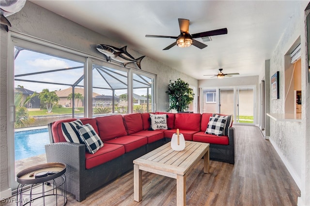 living room featuring ceiling fan and hardwood / wood-style floors