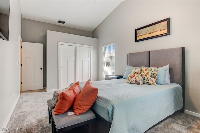 carpeted bedroom featuring vaulted ceiling and a closet