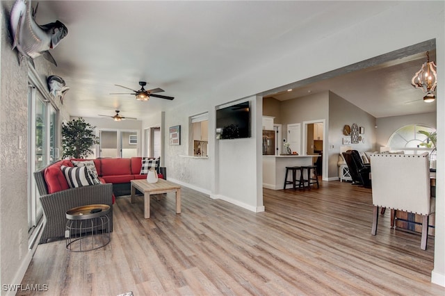 living room featuring ceiling fan and hardwood / wood-style floors