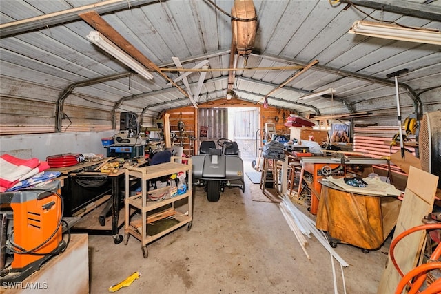 garage with wooden walls and a workshop area