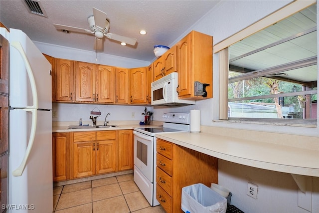 kitchen featuring white appliances, a textured ceiling, light tile patterned floors, sink, and ceiling fan