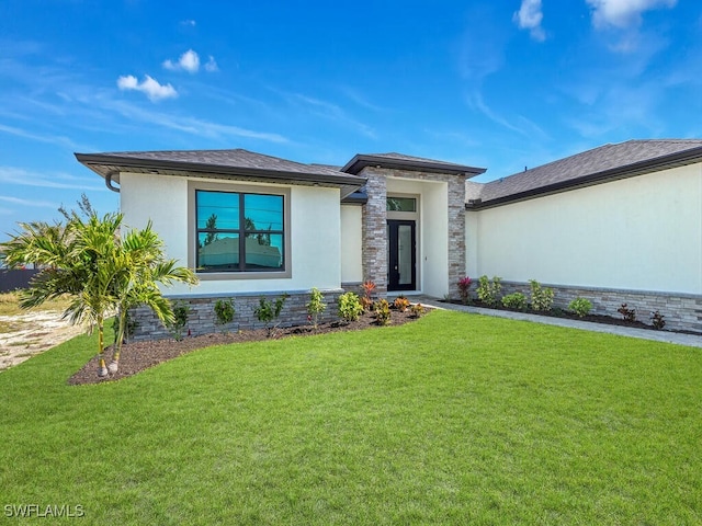 prairie-style house with a front yard and stucco siding