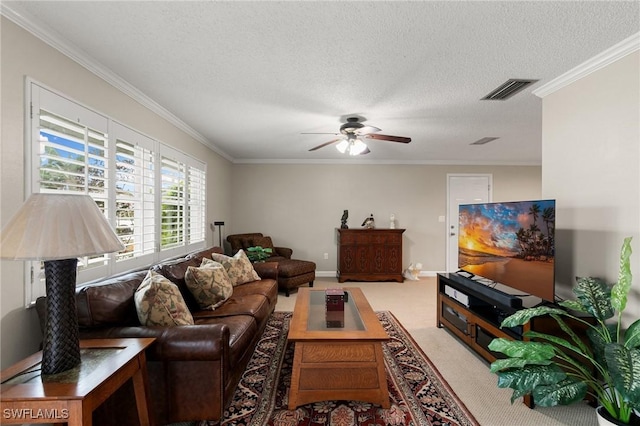 carpeted living room featuring ceiling fan, a textured ceiling, and ornamental molding