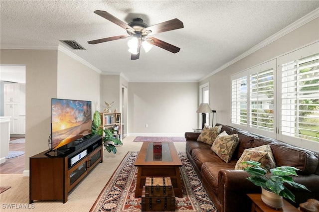 living room with ceiling fan, light colored carpet, a textured ceiling, and ornamental molding