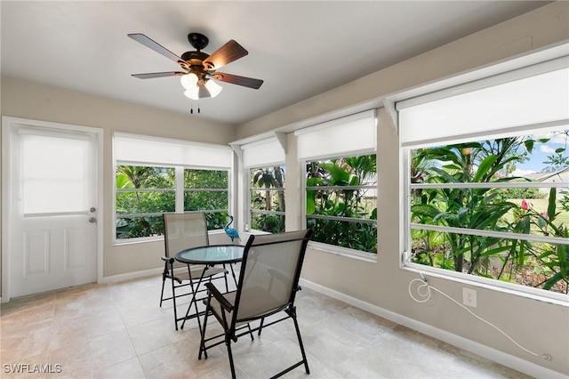 sunroom / solarium featuring ceiling fan