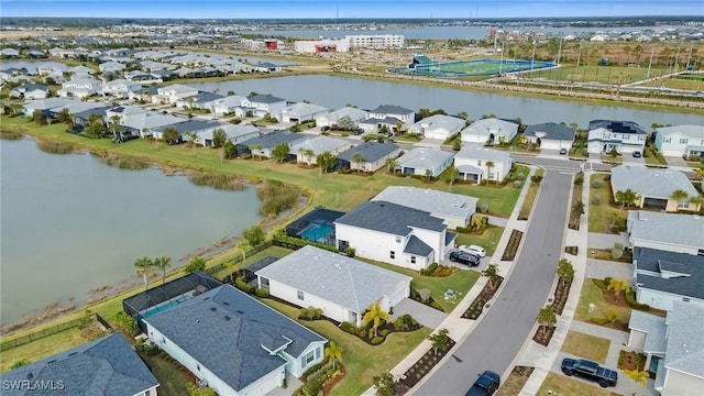 drone / aerial view with a residential view and a water view