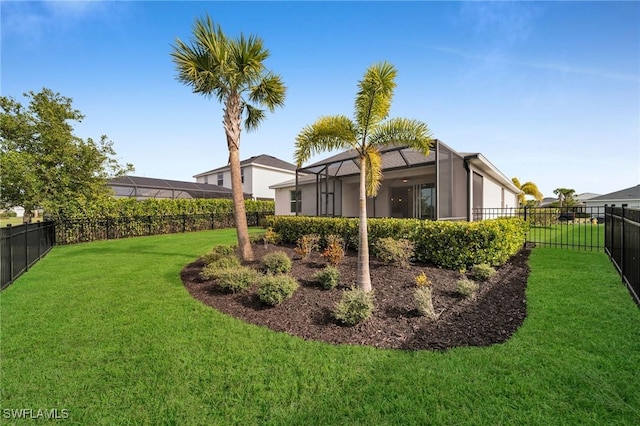 view of yard featuring a fenced backyard and a lanai