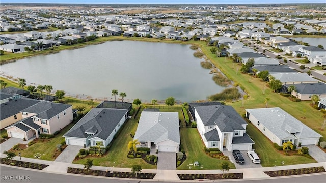 bird's eye view with a residential view and a water view