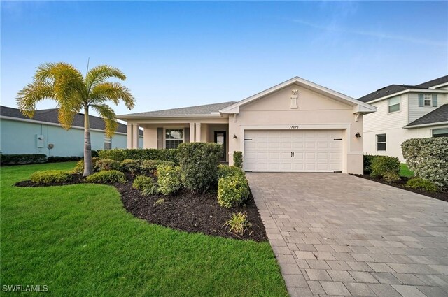 single story home featuring a garage and a front lawn