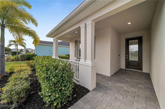 doorway to property featuring stucco siding