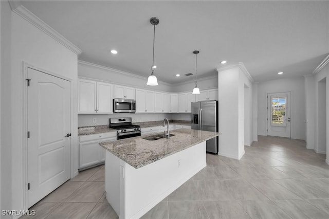 kitchen featuring a center island with sink, white cabinets, light stone counters, appliances with stainless steel finishes, and a sink