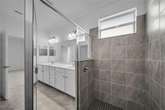 full bath featuring double vanity, visible vents, ornamental molding, and a sink