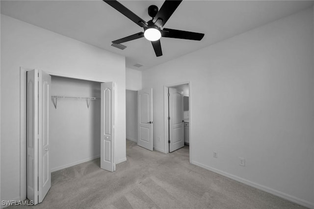 unfurnished bedroom with light carpet, a closet, visible vents, and baseboards