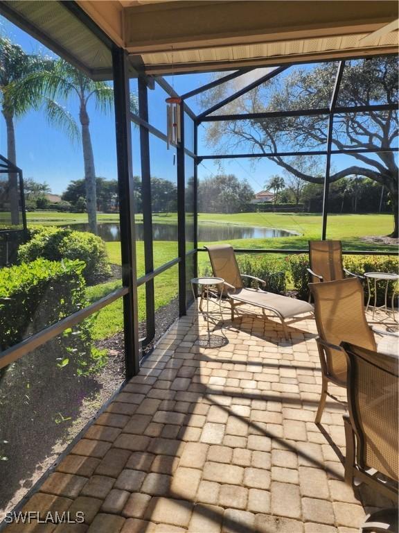 sunroom / solarium with a water view