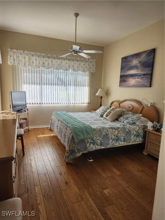 bedroom with ceiling fan and wood-type flooring