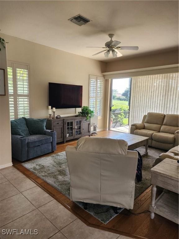 living room featuring ceiling fan and light tile patterned floors