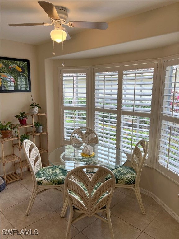 dining area with ceiling fan and light tile patterned floors