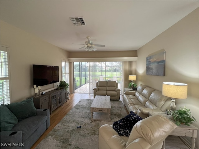 living room featuring ceiling fan and hardwood / wood-style floors