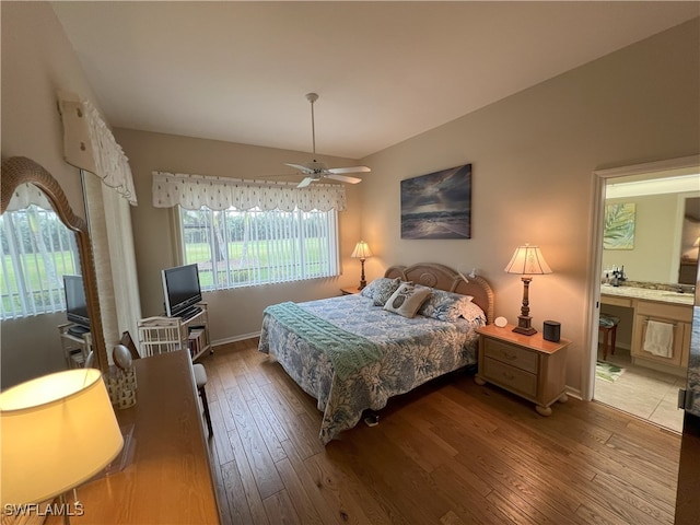 bedroom with ceiling fan, wood-type flooring, and ensuite bath