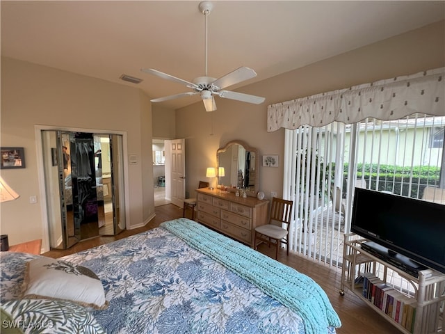 bedroom featuring dark wood-type flooring, a closet, and ceiling fan