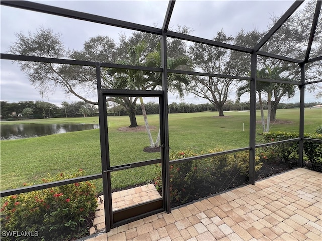 unfurnished sunroom with a water view