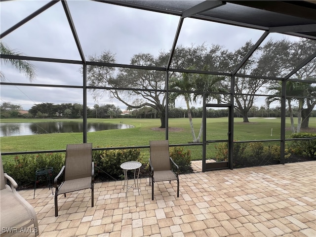 sunroom / solarium featuring a water view