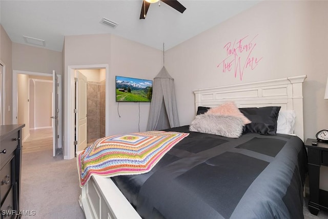 bedroom featuring ceiling fan, light colored carpet, and connected bathroom