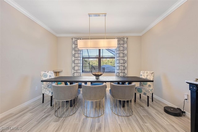 dining room with crown molding and light wood-type flooring