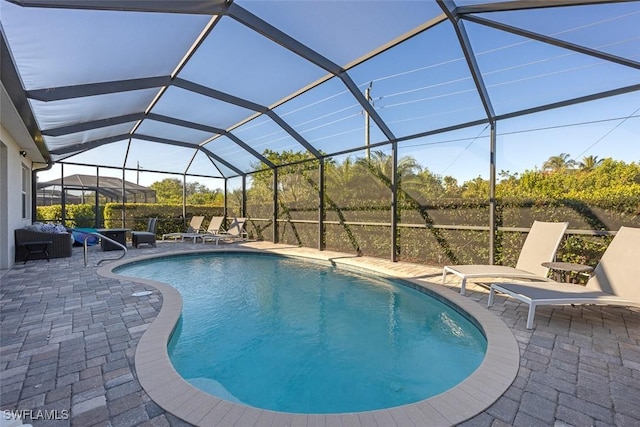 pool with a lanai and a patio area