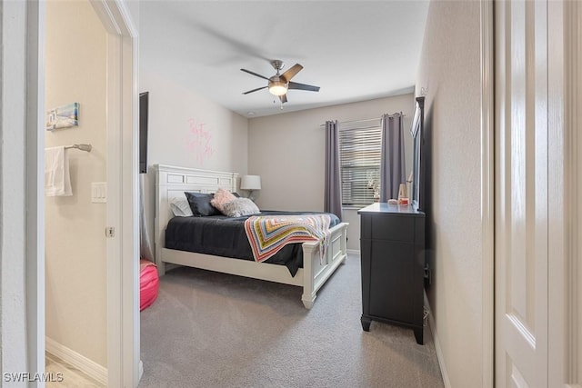 bedroom with ceiling fan and light colored carpet