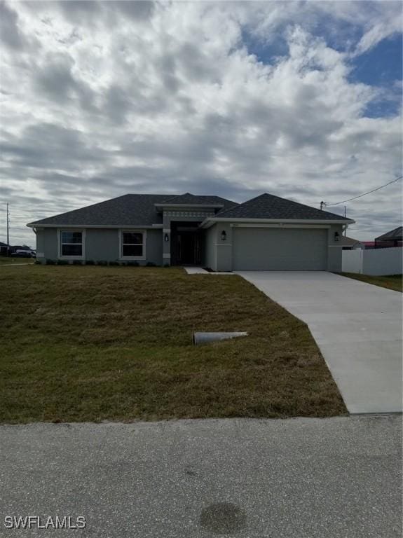 view of front facade with a garage and a front yard