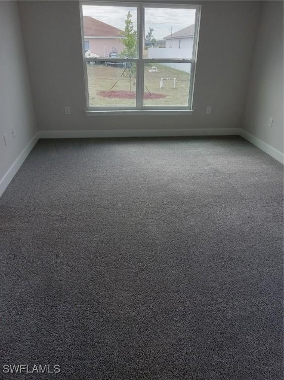 carpeted empty room featuring plenty of natural light