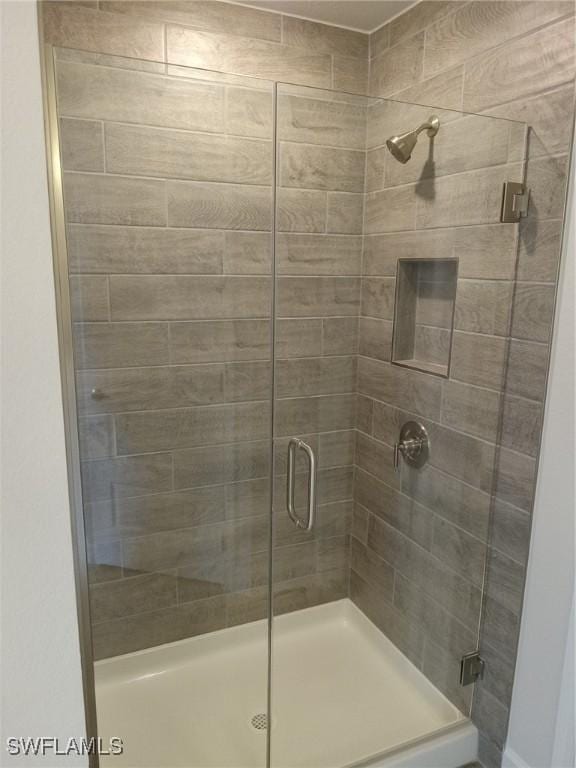 bathroom with a shower with door