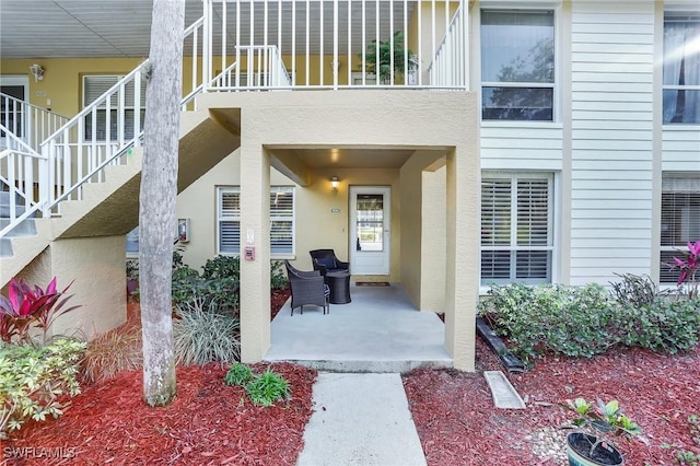 entrance to property with a balcony and a patio