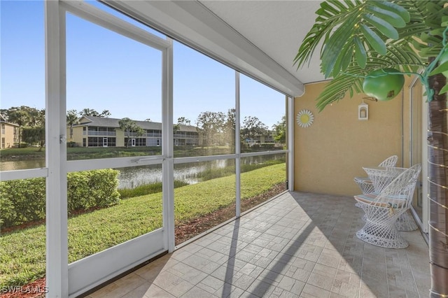 sunroom with a water view and plenty of natural light