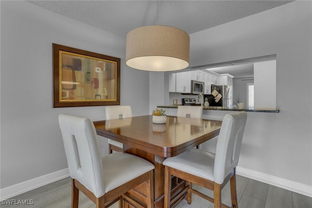 dining area with a textured ceiling