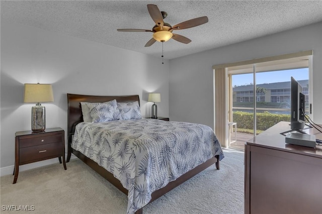 bedroom with access to outside, ceiling fan, light carpet, and a textured ceiling