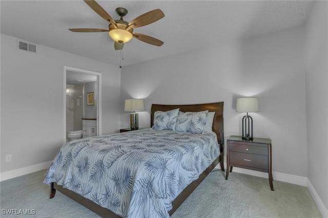 bedroom with ensuite bathroom, ceiling fan, and carpet flooring